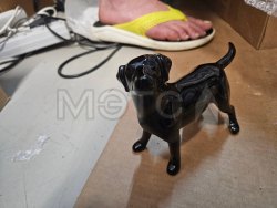 Фигурка черная в виде собаки без маркировки.